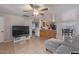 Open-concept living room with tile floors, ceiling fan, and updated island at 6960 W Berkeley Rd, Phoenix, AZ 85035