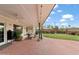 Covered patio leading to a spacious backyard featuring outdoor furniture, a pool, and lush landscaping at 710 E Hayward Ave, Phoenix, AZ 85020