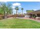 Lush backyard featuring a petite pool, verdant lawn, and an inviting outdoor living space at 710 E Hayward Ave, Phoenix, AZ 85020