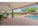 Entertainer's backyard featuring a covered patio, outdoor furniture, pool, lounge chairs, and manicured landscaping at 710 E Hayward Ave, Phoenix, AZ 85020