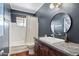 Modern bathroom with a white tub, dark walls, and granite vanity at 710 E Hayward Ave, Phoenix, AZ 85020