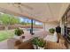 Relaxing covered patio with wicker furniture, ceiling fans, and views of the pool and backyard at 710 E Hayward Ave, Phoenix, AZ 85020