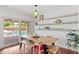 Bright dining room with a wooden table, stylish decor, and view of the backyard pool at 710 E Hayward Ave, Phoenix, AZ 85020