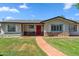 Charming single-story home featuring a bright red front door and meticulously maintained landscaping at 710 E Hayward Ave, Phoenix, AZ 85020