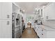 Bright white kitchen featuring stainless steel appliances and tile flooring at 710 E Hayward Ave, Phoenix, AZ 85020