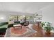 Bright and airy living room with hardwood floors, a comfortable green sofa, and a dining area at 710 E Hayward Ave, Phoenix, AZ 85020