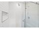 Close-up of the glass shower with subway tile and recessed storage at 710 E Hayward Ave, Phoenix, AZ 85020