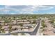 Wide aerial view of this residential neighborhood featuring desert landscaping, tile roofs, and mountain views at 7472 E Black Rock Rd, Scottsdale, AZ 85255