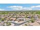 Scenic aerial view of a desert neighborhood featuring tile roofs, mature landscaping, mountain views, and a backyard pool at 7472 E Black Rock Rd, Scottsdale, AZ 85255