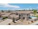 Stunning aerial view of a two-story home with a tile roof, a sparkling pool, and desert landscaping at 7472 E Black Rock Rd, Scottsdale, AZ 85255