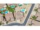 Bird's-eye view features a backyard pool and lush green landscaping in a neighborhood with tile roofs and mature trees at 7472 E Black Rock Rd, Scottsdale, AZ 85255