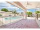 View from the covered patio overlooking the sparkling pool and landscaped backyard at 7472 E Black Rock Rd, Scottsdale, AZ 85255