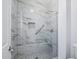 Modern walk-in shower with sleek glass door, beautiful tile surround, and convenient grab bars at 7472 E Black Rock Rd, Scottsdale, AZ 85255