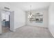 Elegant dining area features a modern chandelier and a backyard pool view at 7472 E Black Rock Rd, Scottsdale, AZ 85255