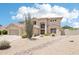 Inviting two-story home with a well-manicured desert landscape and a tile roof at 7472 E Black Rock Rd, Scottsdale, AZ 85255