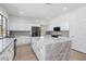 Bright kitchen with white cabinets, a large island with marble countertop, and stainless appliances at 7472 E Black Rock Rd, Scottsdale, AZ 85255