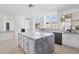 Open-concept kitchen featuring a center island, white cabinetry, and stainless steel appliances at 7472 E Black Rock Rd, Scottsdale, AZ 85255