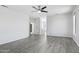 Open living room with gray wood floors, white walls, and modern ceiling fan providing a bright and spacious feel at 7472 E Black Rock Rd, Scottsdale, AZ 85255