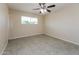 Light-filled bedroom features neutral walls, tile flooring, and ceiling fan at 8227 E Heatherbrae Dr, Scottsdale, AZ 85251