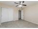 Comfortable bedroom with tile flooring, a ceiling fan, and closet for storage at 8227 E Heatherbrae Dr, Scottsdale, AZ 85251