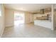 Modern kitchen and living space featuring white cabinets and a breakfast bar at 8227 E Heatherbrae Dr, Scottsdale, AZ 85251