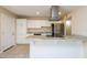 Bright kitchen featuring granite countertops, stainless appliances, and white cabinetry at 8227 E Heatherbrae Dr, Scottsdale, AZ 85251