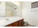 Bathroom featuring a dark wood cabinet, large mirror, and tiled flooring at 9148 W Meadow Dr, Peoria, AZ 85382