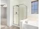Well-lit bathroom featuring a soaking tub and glass-enclosed shower at 9148 W Meadow Dr, Peoria, AZ 85382