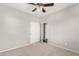 Carpeted bedroom including ceiling fan, double door closet, and access to other rooms at 9148 W Meadow Dr, Peoria, AZ 85382