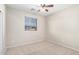 Bright bedroom with neutral carpet, fan, and natural light from the window at 9148 W Meadow Dr, Peoria, AZ 85382