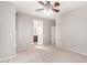 Spacious carpeted bedroom with ceiling fan, and ensuite bathroom, offering comfort and functionality at 9148 W Meadow Dr, Peoria, AZ 85382
