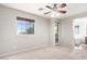 Bedroom with neutral walls, carpet, ceiling fan, and access to a balcony at 9148 W Meadow Dr, Peoria, AZ 85382