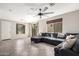 Bright living room with tile flooring, sectional sofa, large windows, and modern ceiling fan at 9148 W Meadow Dr, Peoria, AZ 85382