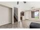 Open-concept living area featuring tile flooring, staircase, and view of a kitchen at 9148 W Meadow Dr, Peoria, AZ 85382