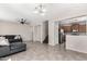 Open-concept living area featuring tile flooring, staircase, and view of a kitchen at 9148 W Meadow Dr, Peoria, AZ 85382