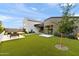 Expansive backyard with artificial turf, modern patio furniture, and a view of the contemporary home at 1013 W Ardmore Rd, Phoenix, AZ 85041
