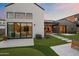 Backyard featuring artificial turf, a stone pathway, and a patio with an outdoor dining area at 1013 W Ardmore Rd, Phoenix, AZ 85041