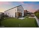 Wide backyard view featuring a putting green, patio with seating, and a modern two-story home at 1013 W Ardmore Rd, Phoenix, AZ 85041