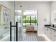 Bright bathroom featuring mosaic floors, glass shower, modern vanity and an open view to the bedroom and outside at 1013 W Ardmore Rd, Phoenix, AZ 85041