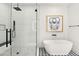 Stylish bathroom featuring a freestanding tub, glass-enclosed shower, and modern finishes at 1013 W Ardmore Rd, Phoenix, AZ 85041