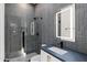 Sleek bathroom featuring gray tile, modern fixtures, a glass shower, and an illuminated mirror for a spa-like experience at 1013 W Ardmore Rd, Phoenix, AZ 85041