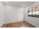 Clean bedroom with hardwood floors and natural light shining through the window at 1013 W Ardmore Rd, Phoenix, AZ 85041