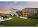 Wide view of the backyard featuring artificial turf, putting green, seating area, and modern home architecture at 1013 W Ardmore Rd, Phoenix, AZ 85041
