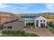 A modern desert home showcasing a brick driveway, three garages, and mountain views at 1013 W Ardmore Rd, Phoenix, AZ 85041