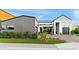 Eye-catching exterior of a modern house featuring a gray garage, brick driveway, and manicured artificial lawn at 1013 W Ardmore Rd, Phoenix, AZ 85041