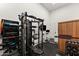 A home gym with mounted tv, exercise equipment, and storage at 1013 W Ardmore Rd, Phoenix, AZ 85041