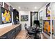 Comfortable home office featuring built-in cabinets, hardwood floors, modern desk, and sports memorabilia at 1013 W Ardmore Rd, Phoenix, AZ 85041