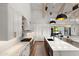 Bright, open kitchen featuring a large island, stainless steel appliances, and modern lighting at 1013 W Ardmore Rd, Phoenix, AZ 85041