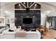 Cozy living room featuring a fireplace, wooden beam ceilings and modern furnishings at 1013 W Ardmore Rd, Phoenix, AZ 85041