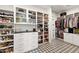 Custom walk-in closet features glass shelving, drawers, and extensive shoe storage for organization and display at 1013 W Ardmore Rd, Phoenix, AZ 85041